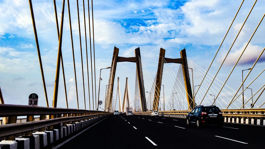 Vibrant view of a modern cable-stayed bridge in Mumbai under a clear blue sky.